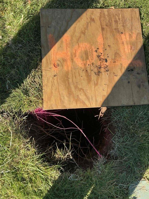 Performed drain cleaning on the main sewer line, accessing the system through an excavated cleanout location in the yard to clear the blockage and restore proper flow. Verified drainage from the interior bathroom fixtures after service, with no visible leaks, moisture, or damage observed, and the excavation was marked and covered with a plywood board for safety.