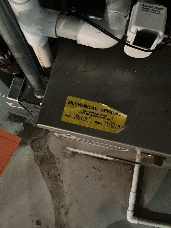 Performed a rental property inspection of one gas furnace and one water heater. Conducted a visual inspection of the furnace, confirming a current municipal mechanical approval sticker, condensate drain piping, and electrical conduit connections. Used a borescope to examine the heat exchanger, which revealed a visible crack or fracture along the tube surface, indicating a potential safety concern that warrants further evaluation or repair.