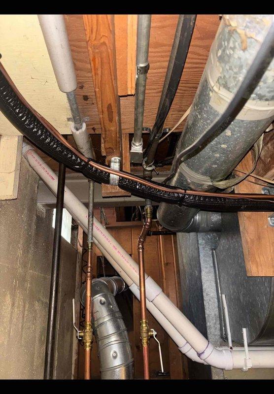 Evaluated the home's accessible basement plumbing in response to recurring bathtub drain clogs and a request to replace aging galvanized piping. Inspection of the exposed overhead piping revealed galvanized supply lines with surface corrosion at fittings and couplings, alongside copper supply lines with brass shutoff valves and PVC drain piping with no visible leaks. Documented existing conditions with photographs to support a repiping scope and estimate for replacement of the corroded galvanized lines and further evaluation of the drain line contributing to the clogs.