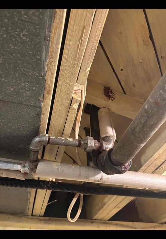Evaluated the home's accessible basement plumbing in response to recurring bathtub drain clogs and a request to replace aging galvanized piping. Inspection of the exposed overhead piping revealed galvanized supply lines with surface corrosion at fittings and couplings, alongside copper supply lines with brass shutoff valves and PVC drain piping with no visible leaks. Documented existing conditions with photographs to support a repiping scope and estimate for replacement of the corroded galvanized lines and further evaluation of the drain line contributing to the clogs.