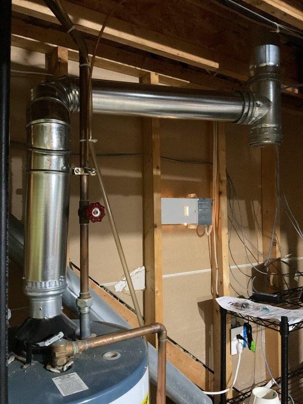 Responded to a reported water leak at an EnergiAir furnace and inspected the furnace and surrounding mechanical area, including the adjacent gas-fired water heater, its vent connector, and the supply piping and shutoff valve. Photo documentation of the mechanical space was taken, and no active leak source was documented at the time of inspection. Further diagnostics, such as checking the furnace condensate drain, trap, and secondary drain pan, are recommended if the leak recurs.