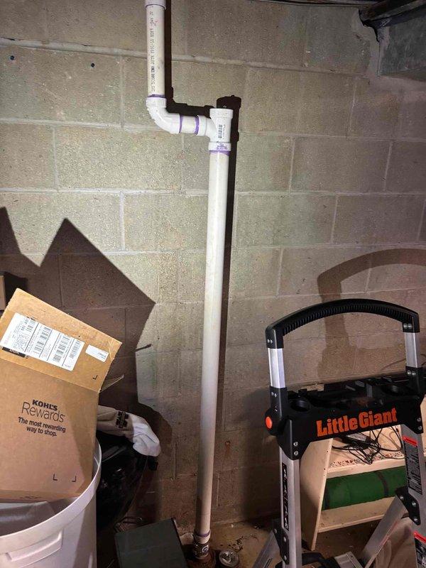 Responded to a basement drain backup causing water intrusion by accessing the floor drain and cleanout fitting at the base of the vertical PVC drain stack. Cleared the blockage from the drain line using drain cleaning equipment, restored proper flow, and verified the line drained freely without backing up.