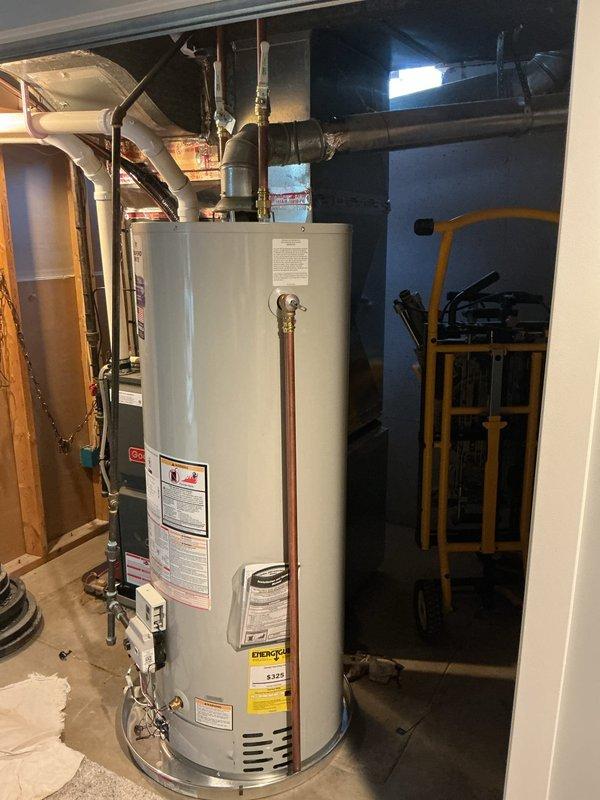 Installed a new 50-gallon natural gas, non-direct vent (atmospheric) Bradford White water heater in the existing mechanical closet, positioned on a drain pan. Connected the copper hot and cold supply lines with shutoff valves, reconnected the gas supply line and control valve, and tied the galvanized flue into the existing vent. Verified connections were secure and free of leaks, and the unit was left operational with no visible leaks, rust, or corrosion.