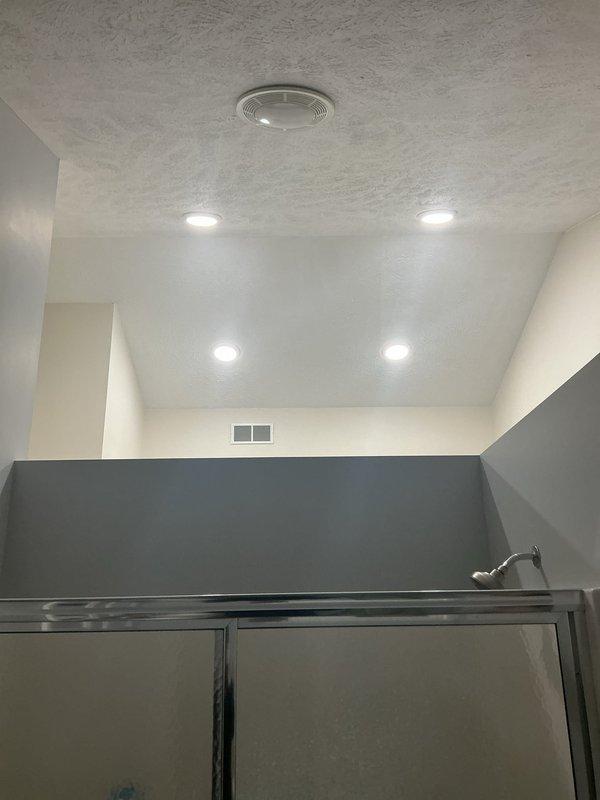 Replaced the bathroom exhaust fans, installing new ceiling-mounted fan units with integrated light lenses and securing the grilles flush to the textured ceiling. Verified proper operation and airflow at each unit, and confirmed the surrounding ceiling surfaces and fixtures were left clean and undamaged.