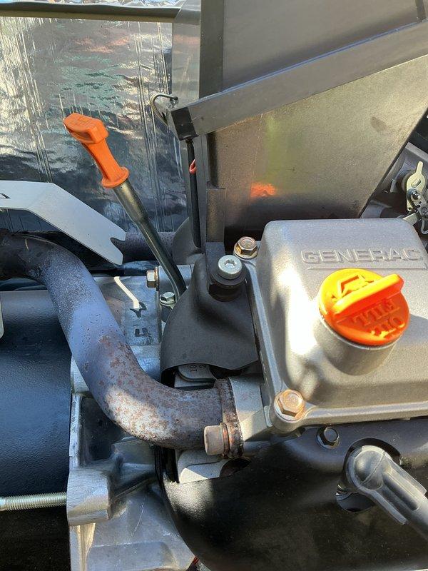 Performed a 4-year scheduled tune-up on a 2022 Generac standby generator, including inspection of the engine compartment, alternator housing, oil system, and exhaust components. Components were found clean with no leaks or damage, though surface corrosion was noted on the exhaust pipe near the engine flange connection and should be monitored during future maintenance visits.