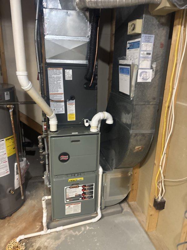 Replaced the existing air conditioning system with a new split-system AC, including the outdoor condenser set on the existing concrete pad and a new evaporator coil matched to the basement gas furnace. Connected the refrigerant lineset, condensate drain, and electrical disconnect, then evacuated and charged the system and verified proper operation and cooling performance.