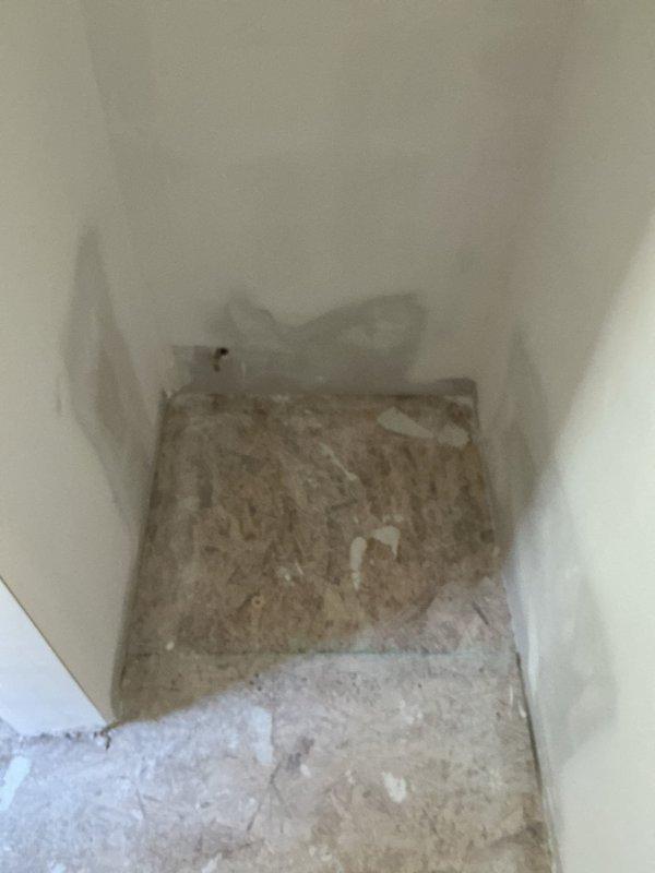 Assessed the renovation area for reconnection of the toilet, sinks, and shower fixtures. Site is currently unfinished, with bare OSB subflooring, patched drywall, and an uncountered base cabinet in place. Fixture reconnection will proceed once finishes and cabinetry are complete.