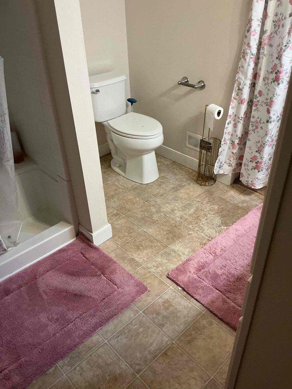 Responded to a slow-draining shower with gurgling at the toilet, indicating a partial obstruction in the main drain line shared by both fixtures. Cleared the blockage using drain cleaning equipment and restored full flow, then verified proper drainage at the shower and confirmed the toilet no longer gurgled during operation.