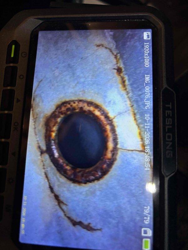 Responded to a no-heat call on a 7-year-old furnace with no heat to the entire home. Performed a visual inspection of the heat exchanger using a borescope, which revealed heavy rust, corrosion, and pitting around a weld joint/opening, indicating heat exchanger failure. Shut off the gas and electrical supply to the furnace, documented the findings with photos, and issued a heat exchanger warning notice outlining the carbon monoxide risk and the need for heat exchanger or furnace replacement; customer acknowledged the notice with a signature.