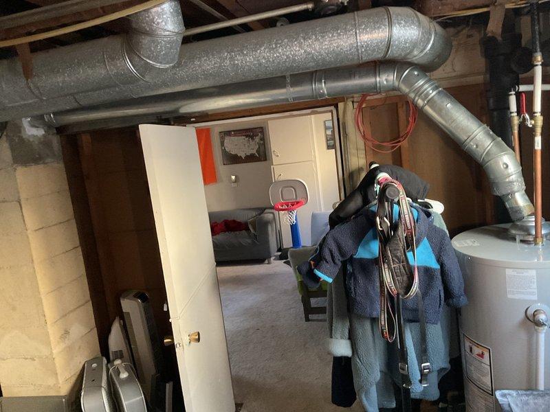 Inspected the 16-year-old furnace for a loud, labored operating noise and evaluated the blower assembly, motor, and supply ductwork for signs of excessive airflow restriction or mechanical wear. Checked the adjacent ductwork and venting, including the water heater flue connection, for secure fittings and proper airflow, and advised on the findings and recommended corrective action to restore quiet, efficient furnace operation.