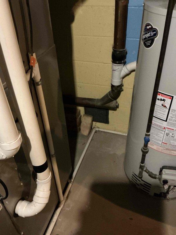 Responded to a clogged basement drain and assessed the drain line, where the aging cast iron/copper stack connects via a rubber coupling to PVC fittings and a horizontal drain run. Evaluated the piping for replacement per the customer's request, and the affected drain section was addressed to restore proper flow.