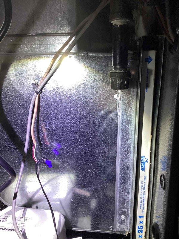 Responded to a no-heat call on a nine-year-old EnergiAir furnace with no power after a reported spark during air filter cover removal. Inspected the filter cabinet and surrounding low-voltage and line-voltage wiring, where photos show wire-nut splices and conductors routed near the filter slot, and checked for shorted or damaged conductors and blown protection. Restored power to the unit and verified normal furnace operation.