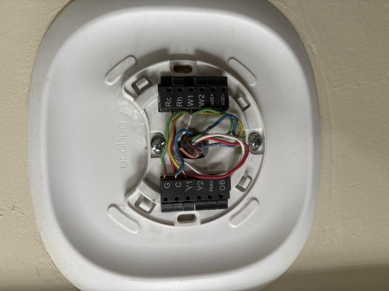 Performed the quoted filter housing modification on the air handler and verified system operation by checking the control board status indicator, low-voltage connections, and electrical readings with a clamp meter. Inspected the thermostat backplate wiring and terminal connections, confirming secure low-voltage conductors at the control terminals, with no visible damage, frost, or corrosion at the unit.