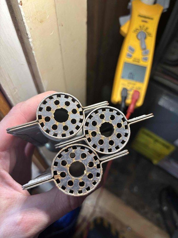 Performed annual heating tune-up on 17-year-old Amana furnace, including inspection of the burner assembly and heat exchanger sections and verification of electrical operation with a multimeter. Identified rust and corrosion on the burner/heat exchanger components, indicating heat exposure and wear, and documented findings with photos for the customer's records.