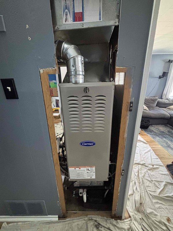 Installed a new Carrier gas furnace in the closet alcove, connecting the flue venting, supply plenum and ductwork, gas and electrical lines, and condensate drain with a condensate pump. Verified all connections, secured the unit, and protected surrounding floors with drop cloths throughout the installation.