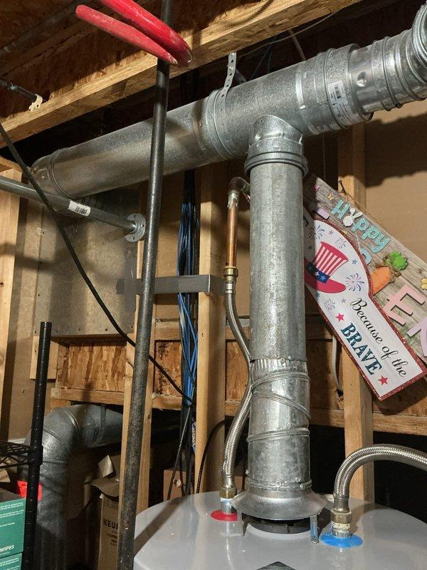 Inspected the AO Smith water heater for a recurring leak and checked the thermal expansion tank, copper supply piping, shutoff valve, and braided stainless flexible connectors for moisture, corrosion, and fitting integrity. No active leaks, rust, or visible damage were found at the connections, tank, or venting, and the system was left operating normally.