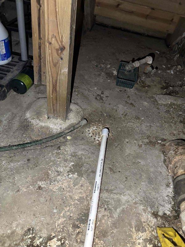 Corrected the furnace condensate discharge to comply with plumbing code by extending the condensate drain line with PVC piping and fittings to terminate at the existing trapped floor drain, eliminating the previous discharge onto the low-spot floor area. Verified the line is properly supported and pitched to drain, ensuring condensate now discharges to an approved location.