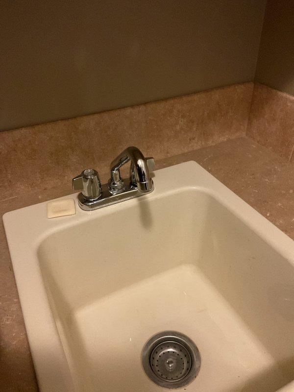 Repaired a leaking two-handle gooseneck sink faucet that would not shut off completely and produced a steady drip. Isolated the water supply, disassembled the faucet handles, and replaced the worn internal valve components (cartridges/seats and seals) responsible for the leak. Reassembled the fixture, restored water flow, and verified full shutoff and leak-free operation at both handles.