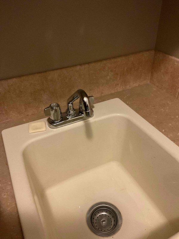 Repaired a leaking two-handle gooseneck sink faucet that would not shut off completely and produced a steady drip. Isolated the water supply, disassembled the faucet handles, and replaced the worn internal valve components (cartridges/seats and seals) responsible for the leak. Reassembled the fixture, restored water flow, and verified full shutoff and leak-free operation at both handles.