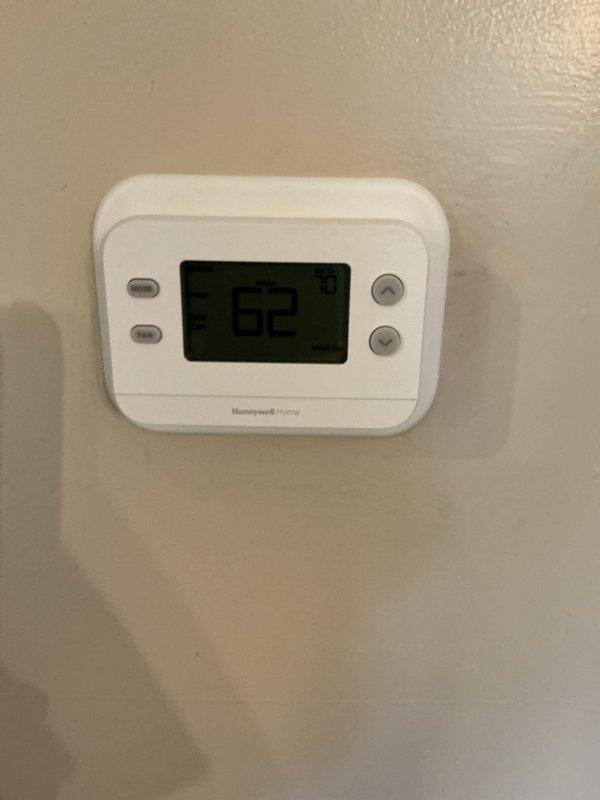 Responded to a no-heat call on a Lennox gas furnace approximately 7 years old and inspected the system, including the Honeywell Home digital thermostat, which displayed an indoor temperature of 62°F against a 70°F setpoint with a "Heat On" call active, confirming the thermostat was signaling for heat while the furnace failed to respond. Performed diagnostic evaluation of the heating equipment, and documented the installation with photos, including the adjacent tankless water heater, venting, and supply piping, with no visible frost, ice, or rust noted.