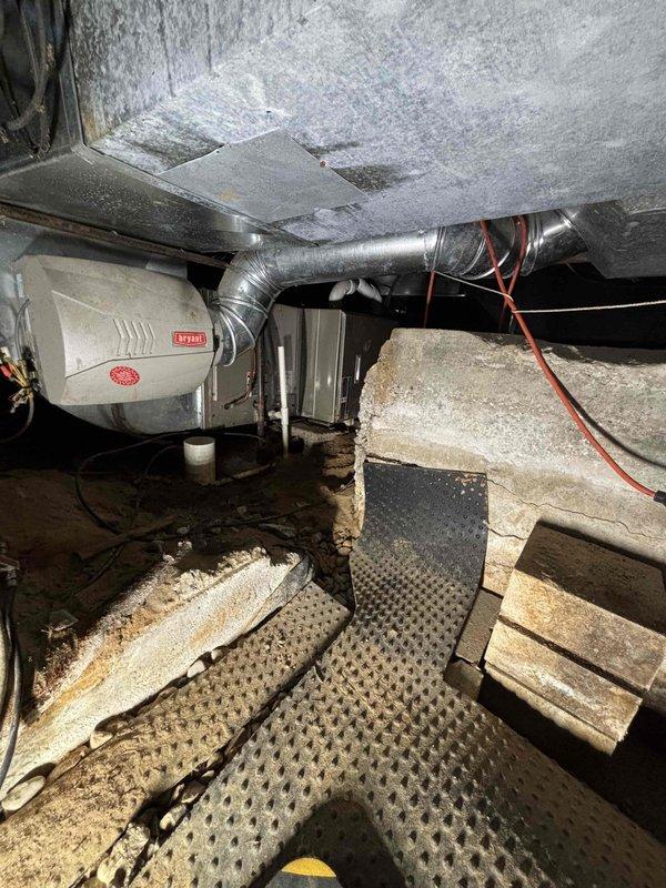Performed annual heating tune-up on a 15-year-old Bryant furnace located in the crawl space, including inspection of the air handler, ductwork, and electrical connections with clamp meter testing of system operation. Inspected the Bryant humidifier and its PVC drain line, and replaced the air filter per client request. Verified proper thermostat control and heating performance.