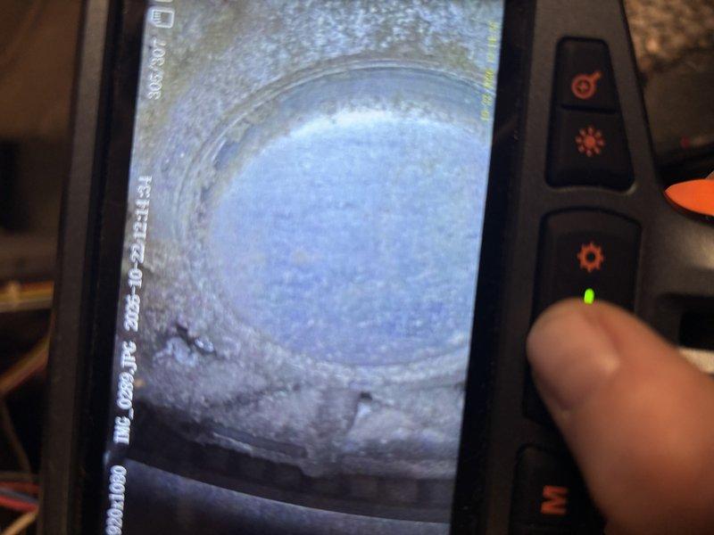 Performed a comprehensive tune-up on a 14-year-old Heil gas furnace, including a borescope inspection of the blower assembly and motor housing, which showed dust and debris accumulation on the blower wheel and interior surfaces. The inspection also revealed heavy scale and corrosion buildup with flaking along the rim and walls of a circular opening in the heat exchanger or flue passage, which should be monitored given the age of the unit. Completed the standard tune-up and verified the furnace is operating safely.