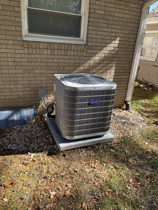 Installed a new Carrier gas furnace with a vented flue assembly, sheet-metal supply plenum, and condensate drain pan, along with an accessory air treatment component, and completed the associated gas, electrical, and drain connections. Installed a matching Carrier outdoor condensing unit on a level concrete pad with insulated refrigerant lines and a weatherproof electrical disconnect, completing the full furnace/AC system replacement.