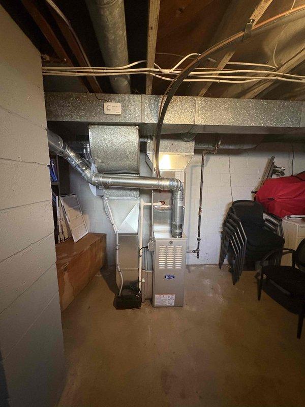 Installed a new Carrier upright gas furnace in the basement, connecting it to the existing supply ductwork and trunk line, gas supply piping, electrical and control wiring, and flue venting. Installed a condensate pump for drainage and verified all connections and system components were secure and properly configured for operation.
