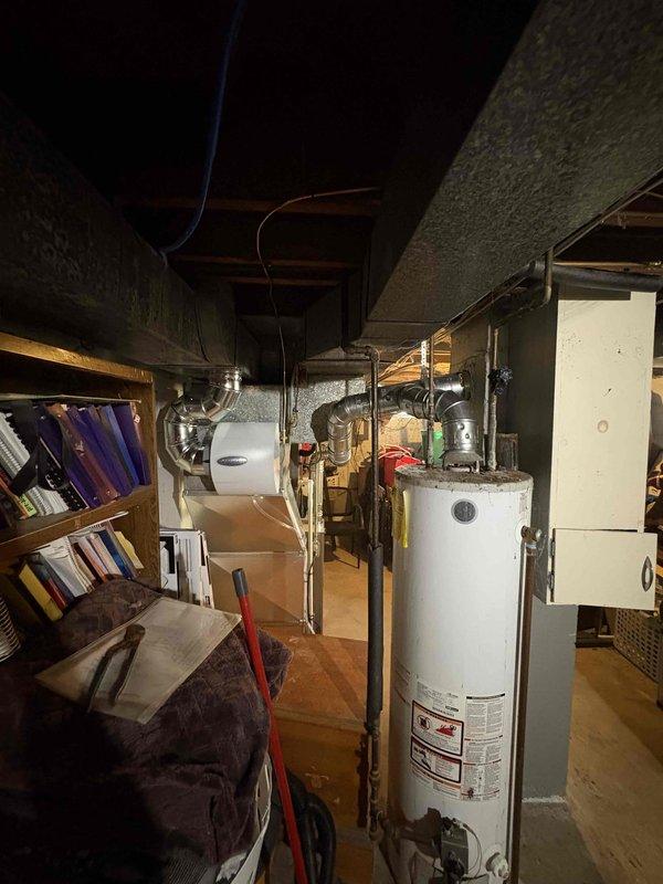 Installed a new Carrier upright gas furnace in the basement, connecting it to the existing supply ductwork and trunk line, gas supply piping, electrical and control wiring, and flue venting. Installed a condensate pump for drainage and verified all connections and system components were secure and properly configured for operation.