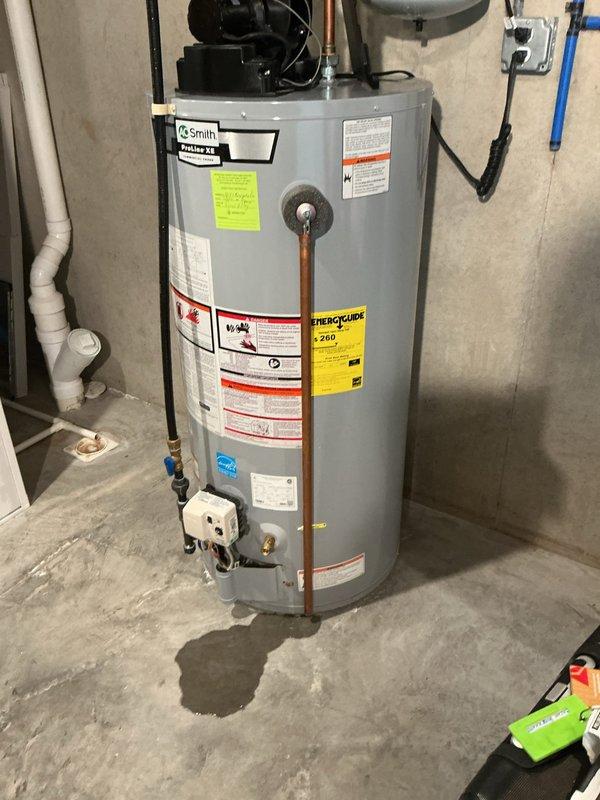 Inspected the A.O. Smith ProLine XE water heater following a reported leak and found moisture pooled on the floor beneath and in front of the unit. Evaluated the connected PEX supply lines, valves, and fittings, along with the tank, to isolate the source of the leak and determine whether the expansion (bladder) tank was a contributing factor.