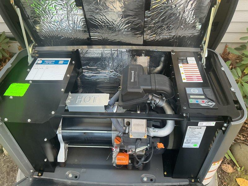 Performed annual preventive maintenance tune-up on a Honeywell standby generator, inspecting the engine compartment, wiring, hoses, exhaust, and control panel. All components were found clean and in good condition, with no visible rust, leaks, or damage. The unit was left operational with no deficiencies noted.