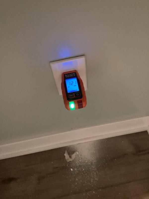 Diagnosed and repaired loose connections causing intermittent operation of the under-cabinet kitchen lighting, and troubleshot and corrected the fault causing flickering at the basement entry door lights. Installed a new receptacle in the laundry room below the existing outlet, then verified correct wiring and 121 VAC output with an outlet tester, confirming proper operation of the circuit.