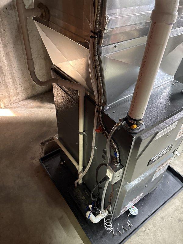 Installed a new gas furnace with a condensing PVC vent and secured condensate drain line, set on a drip pan with new galvanized supply plenum and ductwork transitions. Installed an AprilAire humidifier with humidistat control, connected the associated water supply and drain piping, and completed the electrical and low-voltage connections with the wiring properly secured. Verified the water heater connection and gas control valve, completed unit labeling, and left the service log in place at the equipment.