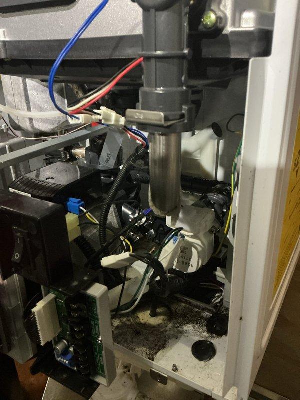 Inspected the tankless water heater after the reported error code and no-heat condition, and found heavy soot and carbon buildup in the cabinet interior. Verified the inlet plumbing, valve assembly, and PCB and wiring connections, and cleaned the unit to restore proper combustion and heat exchanger operation.