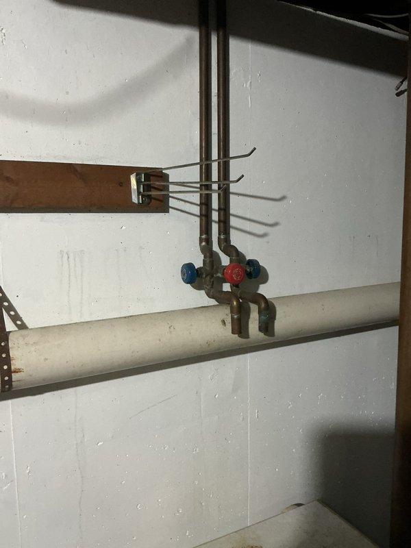 Inspected the tankless water heater after the reported error code and no-heat condition, and found heavy soot and carbon buildup in the cabinet interior. Verified the inlet plumbing, valve assembly, and PCB and wiring connections, and cleaned the unit to restore proper combustion and heat exchanger operation.