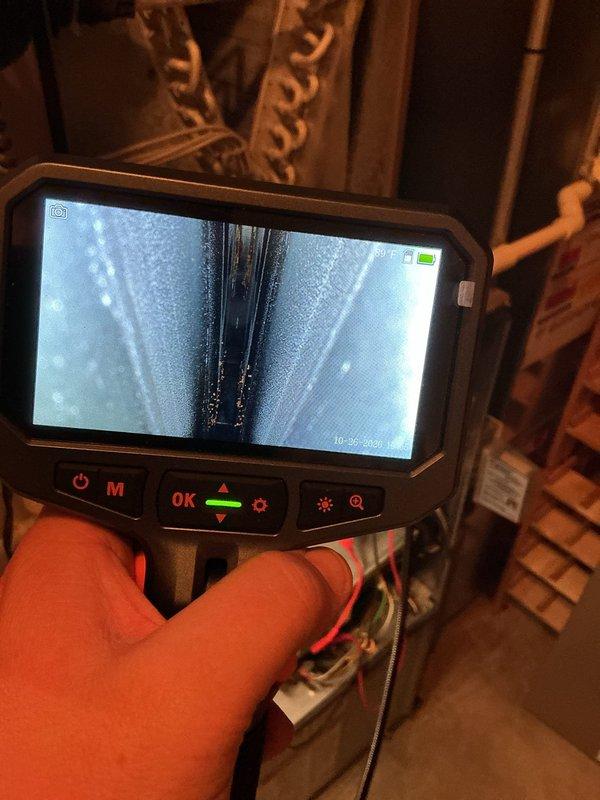 Performed annual heating tune-up on a 15-year-old Bryant furnace with whole-home humidifier. Inspected the evaporator coil and surrounding cabinet using a borescope, which revealed significant frost and ice accumulation on the coil tubes and fins, indicating restricted airflow or a refrigerant-side issue that should be further evaluated. Documented findings with photos and recommended follow-up diagnostics of the cooling system.