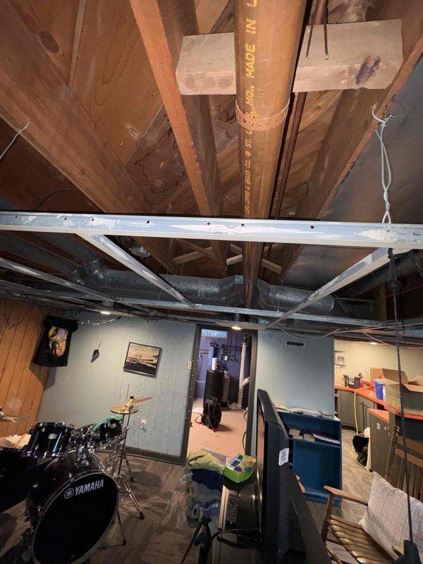 Responded to a reported sewer line backup with leakage at the basement drain pipe. Inspected the cast iron main drain stack and overhead piping at the joist level, including fittings and joints, and documented findings with photos. Identified the condition affecting drain flow and the source of the leakage at the pipe, and advised on the necessary repairs to restore proper drainage.