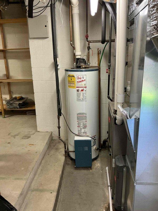 Performed an on-site estimate for replacement of a 25-year-old gas tank water heater (Rheem PowerVent model) in the basement utility area, with the unit inspected and no heavy corrosion or visible damage observed on the tank, venting, or connections. Evaluated replacement options, including a tankless water heater conversion, and documented the installation area and surrounding equipment, noting rust staining on the concrete floor near the furnace drain piping that may indicate past or ongoing moisture. Provided replacement pricing on site per the customer's request for the soonest available installation.