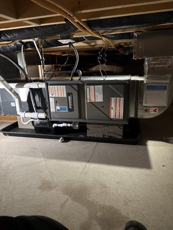Installed a new horizontal gas furnace in the crawl space on a drain pan, with sheet metal supply plenum connected to existing ductwork. Connected gas piping, electrical supply, and PVC condensate drain with condensate pump, and verified all warning labels and installation placards were in place. Unit appears clean and properly secured with no visible damage or leaks.