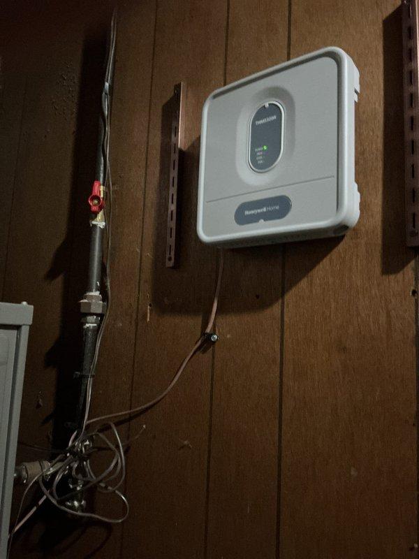 Replaced the failed Honeywell Home digital thermostat with a new unit, navigating the existing low-voltage wire run routed through the ceiling, attic, and back down through the closet wall. Verified proper wiring termination at the subbase and confirmed the display, calibration, and system operation were functioning correctly after installation.