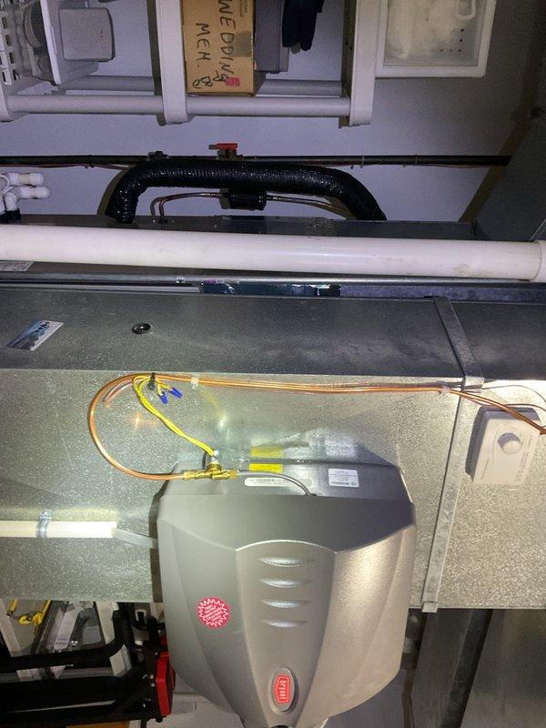 Replaced the failed humidifier solenoid on the Bryant whole-house humidifier and installed a new water supply valve with fresh copper tubing connections. Verified proper water feed to the unit and checked wiring connections to the humidistat control for correct operation.