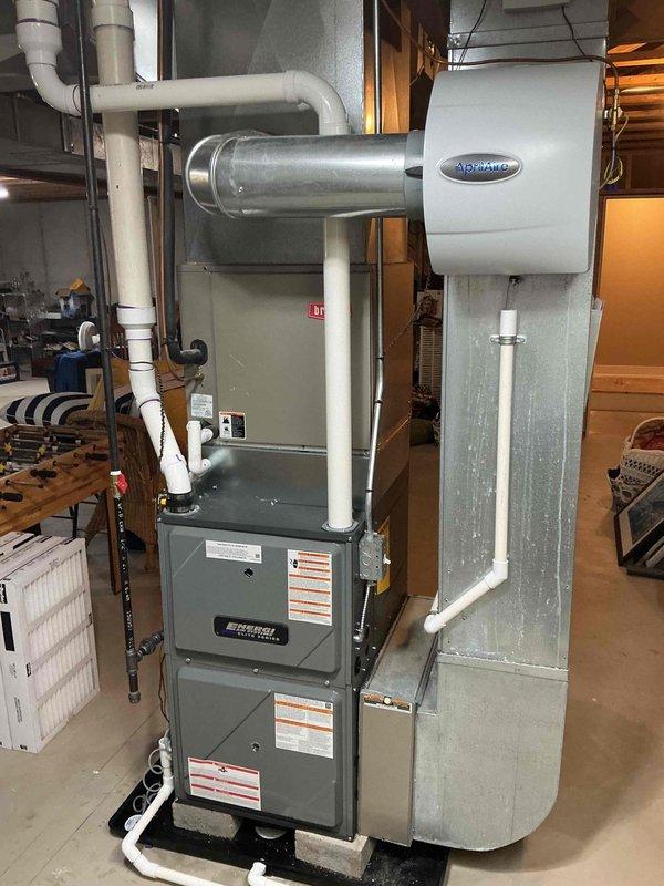 Installed a new gas furnace with matched A/C coil cabinet in the basement mechanical area, connecting it to the existing supply plenum, gas line, and PVC condensate/venting. Reconnected the existing whole-house humidifier to the supply ductwork, verified secure connections, and confirmed proper system operation upon completion.