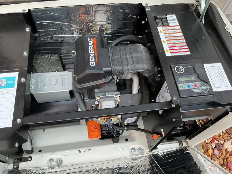 Performed scheduled tune-up on Generac standby generator, including engine oil and filter replacement (1.7 qts capacity) and a full inspection of the enclosure, engine compartment, air intake hose, heat shield, battery, and control panel. All components were found clean and in good condition with no visible rust, cracks, or damage, and the service tag was updated for the next maintenance interval.