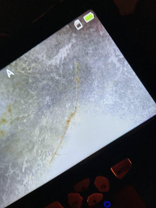 Performed annual heating tune-up on a 24-year-old Carrier furnace and humidifier, including inspection of the system's components for proper operation. Used a borescope to examine the interior surfaces, which revealed surface rust and corrosion consistent with the unit's age, and documented the findings with photos for the service record.