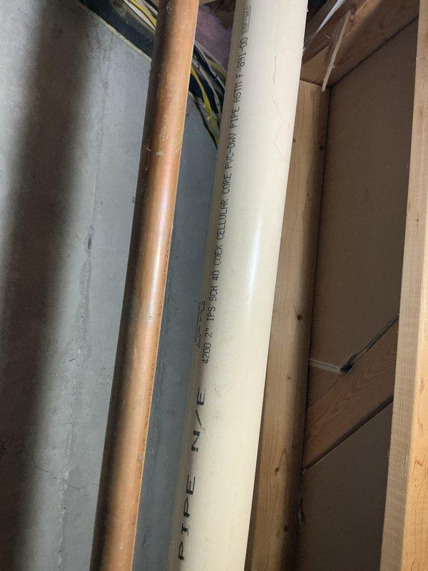 Performed an on-site evaluation of the existing water heater, which had been reported as failing and potentially non-functional, to determine replacement requirements. Inspected the surrounding utility area, including the PVC-DWV drain piping, copper water supply lines, flexible supply connectors, and overhead ductwork, and documented existing conditions with photographs to support replacement planning. No visible frost, rust, or cracking was observed on the accessible piping or ductwork.