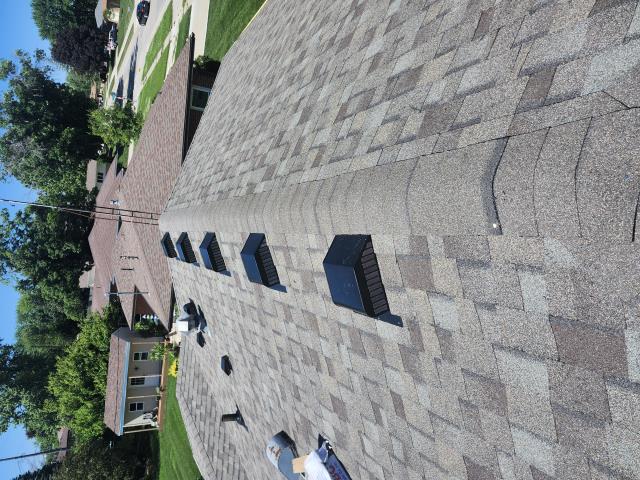 Following a hail storm, we installed a new roof on the house and garage, enhancing both appearance and protection. Our work restored the roof's integrity, ensuring lasting durability.