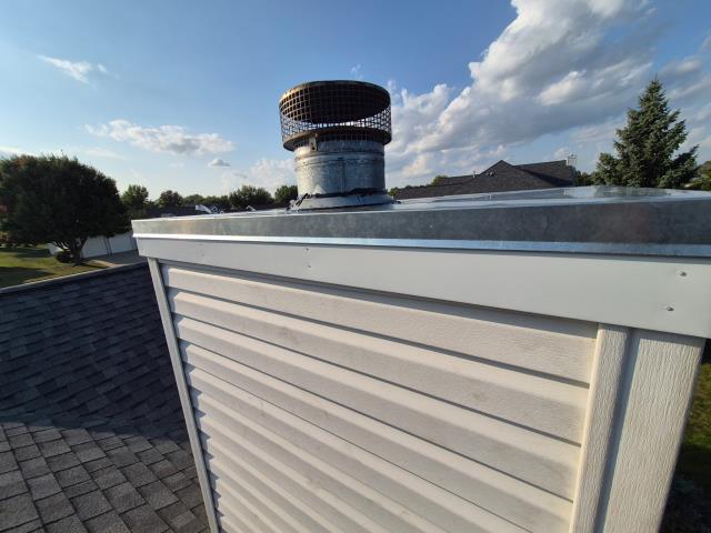 We installed a new chimney cap, repaired the board, wrapped the garage door, and completed fascia work. The homeowner was thrilled with the improved appearance and functionality.