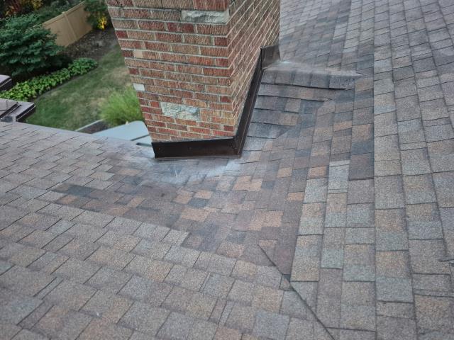 We fixed a leaking chimney by installing a durable cap and securing flashing around its base, ensuring it's now watertight and well-protected.