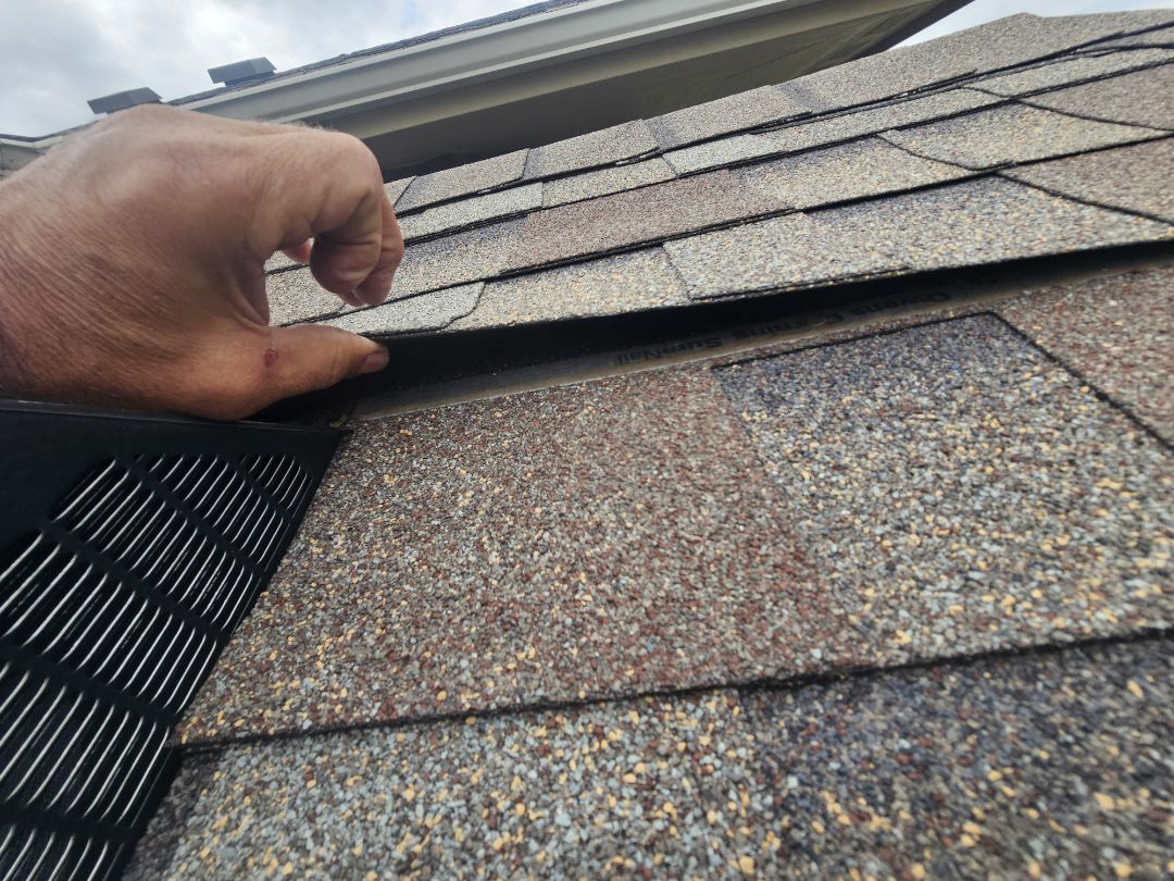 A homeowner reached out with concerns about staining on their living room ceiling. After conducting a thorough inspection, it was determined that the original roof was failing, leading to water penetration due to an improperly installed box vent. A temporary solution was provided, including spray sealant for the stained ceiling, ensuring the homeowner could manage until a permanent fix was implemented. Additionally, the new roof was expected to last 5 to 7 more years. The homeowner was informed about the benefits of post-storm inspections and future assista