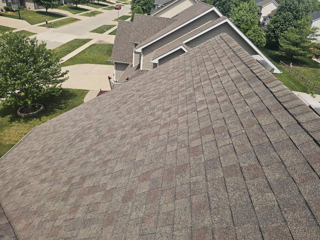 A homeowner contacted us due to concerns about their older roof after recent storms. We conducted a thorough property evaluation, identifying no major issues with the siding but discovering a leak in the irrigation system. The garage door header was severely rotted due to improper flashing. Upon inspecting the roof, we found extensive granule loss, with some areas showing up to 90% granule loss. We took detailed photos and spent time explaining the findings to the homeowner. We provided an estimate for a full roof replacement using class three or four impact-resistant